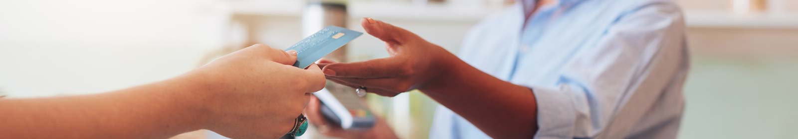 Person using a credit or debit card in a place of business